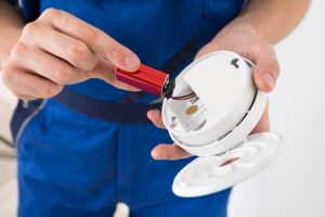 Technician Checking the Battery of a Smoke Detector
