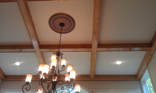 Light fixture hanging from ceiling surrounded by wood