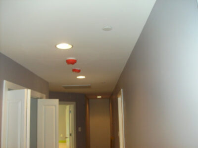 Red sprinklers on ceiling in a hallway